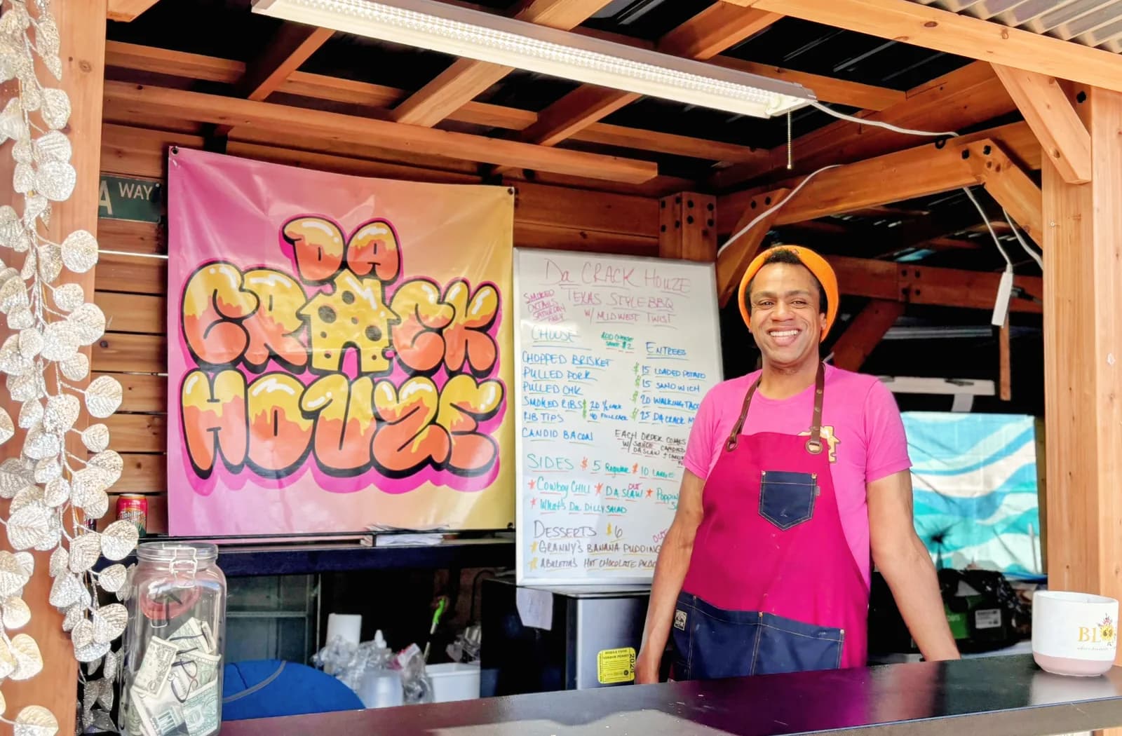 Cory at the Da Crack Houze booth next to the logo banner at the Loves Park Food Park