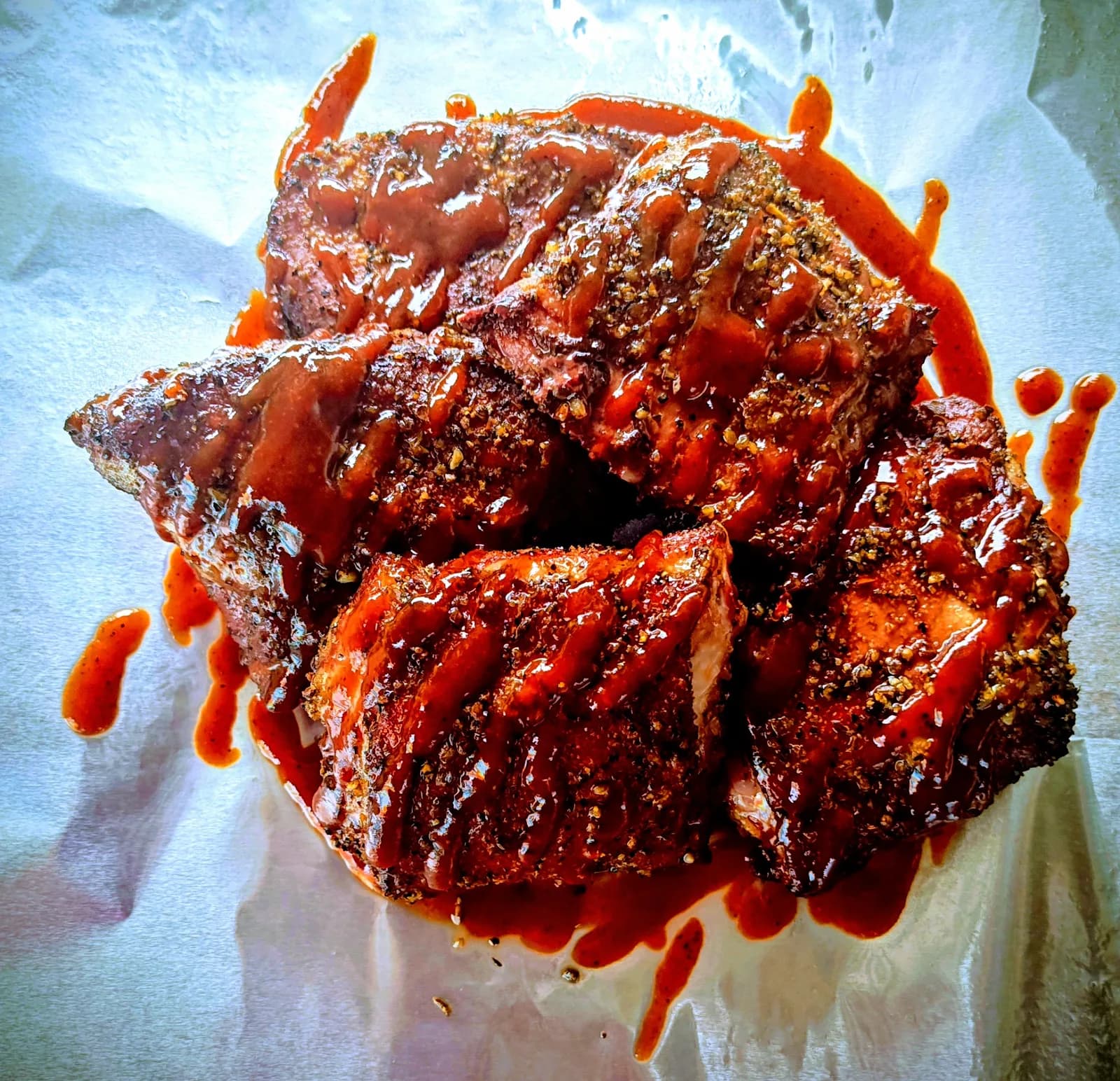 Sauced smoked ribs on butcher paper